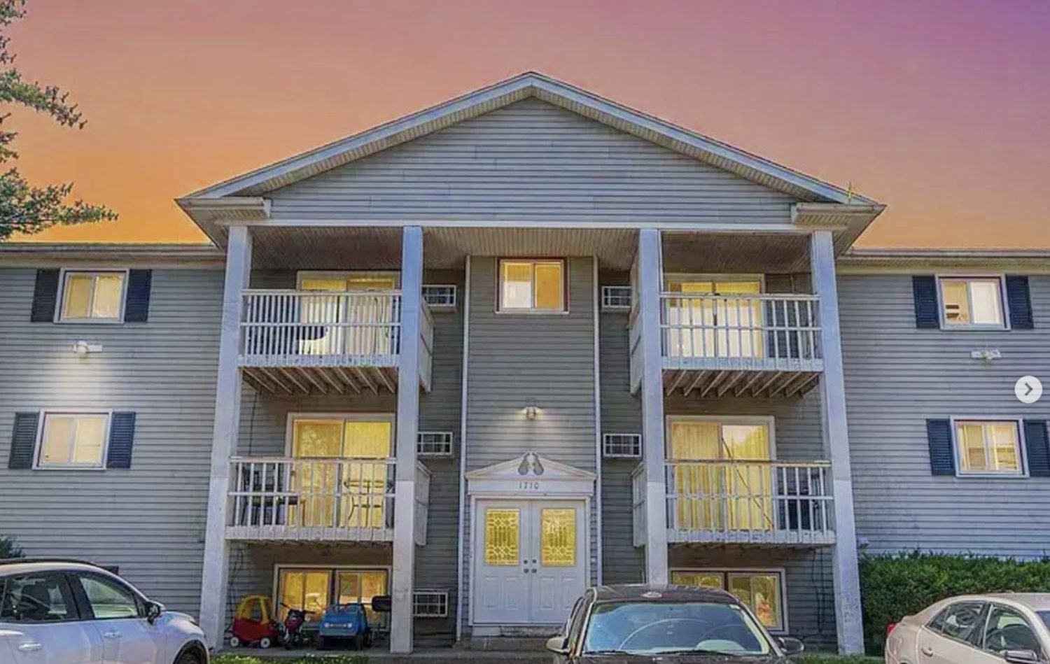 A renovated sixteen-unit apartment building at sunset