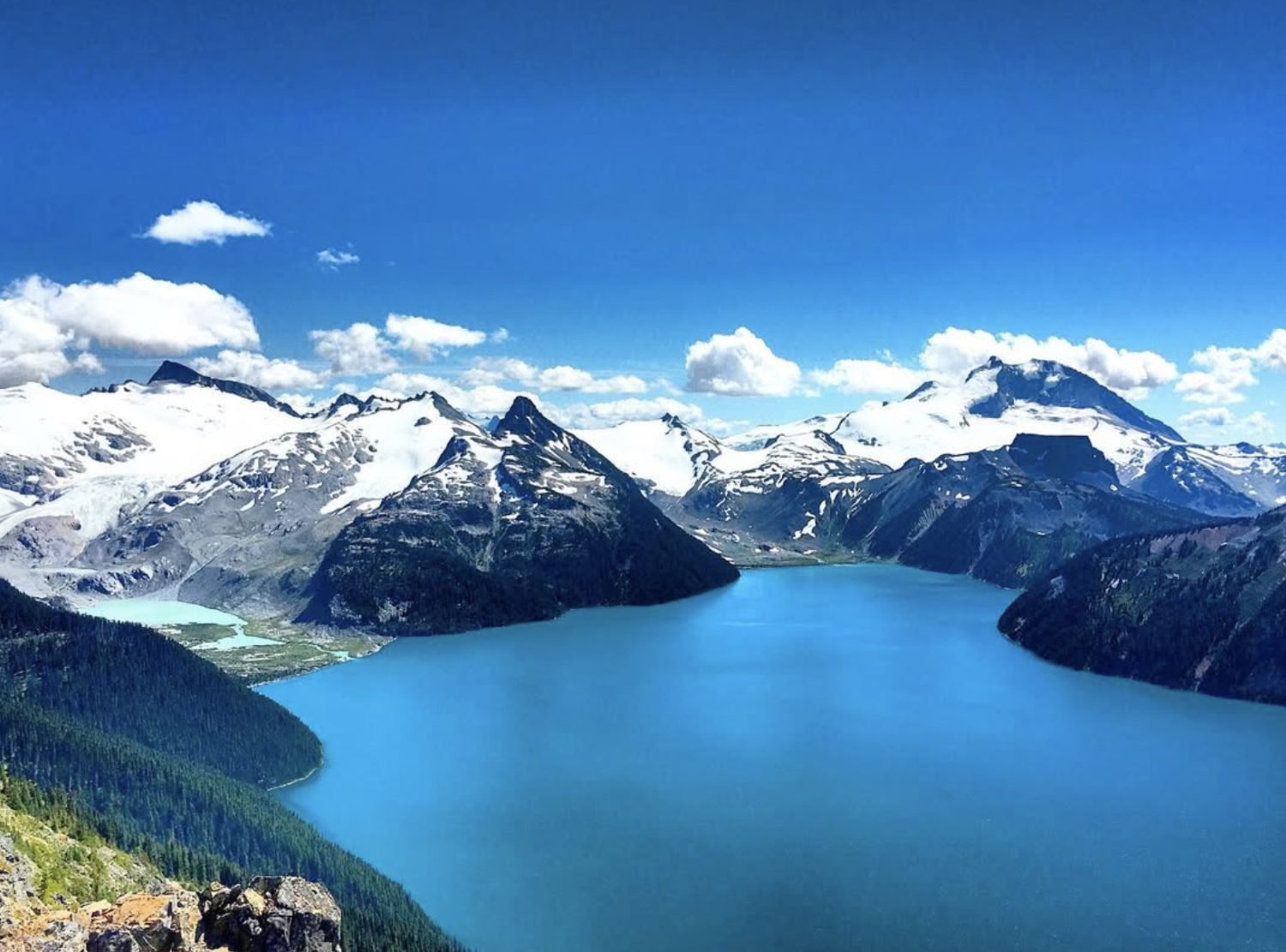 A glacial lake ringed by snow-covered peaks in British Columbia