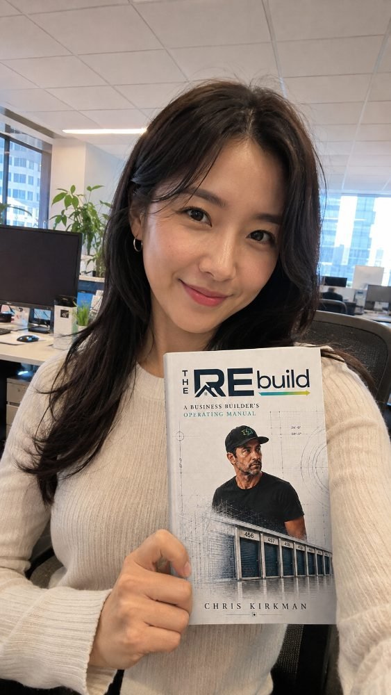 A reader holding The REbuild at her office desk
