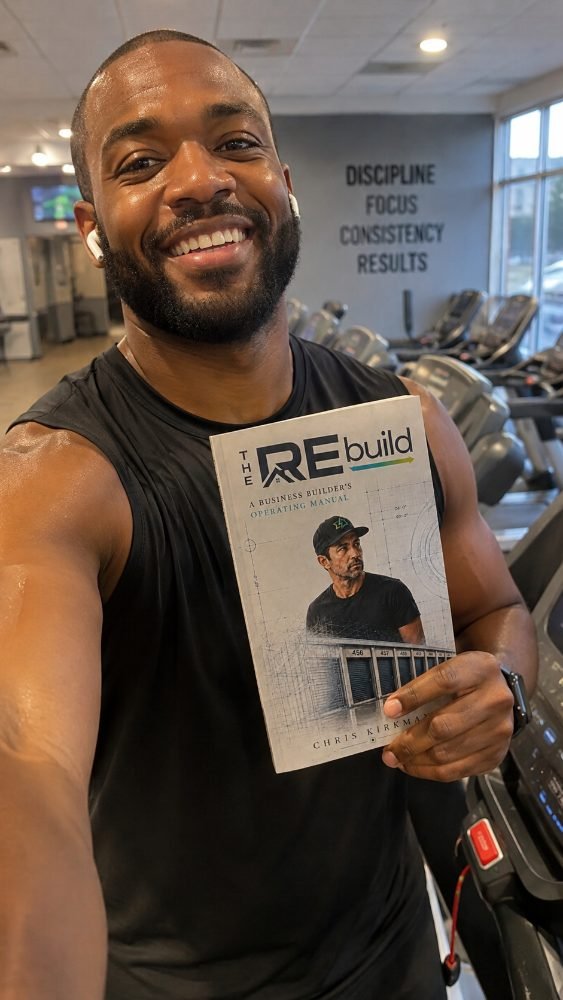 A reader holding The REbuild at the gym