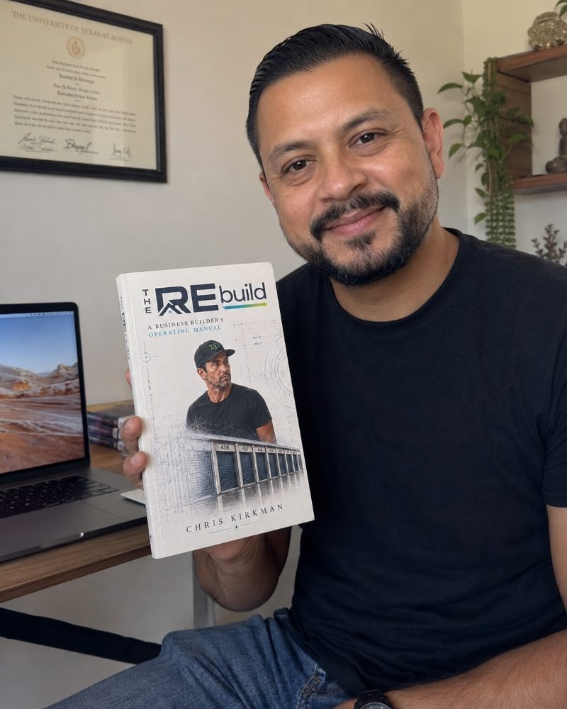 A multifamily investor holding The REbuild in his office