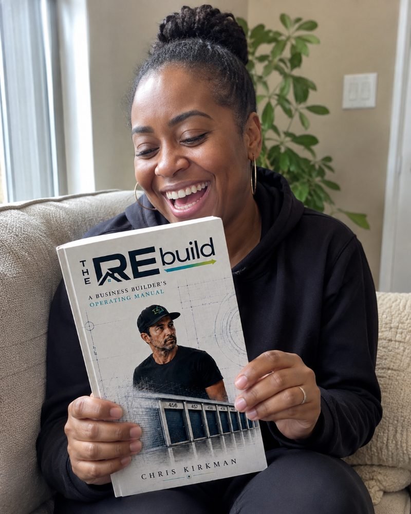 A reader laughing while reading The REbuild on her couch